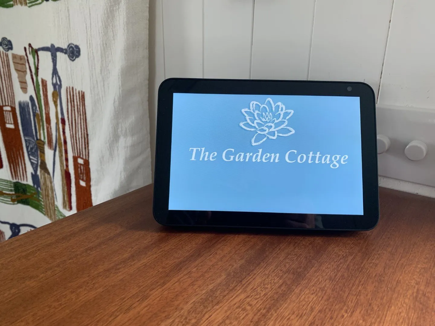 An Amazon Echo smart speaker on a shelf in the cottage.