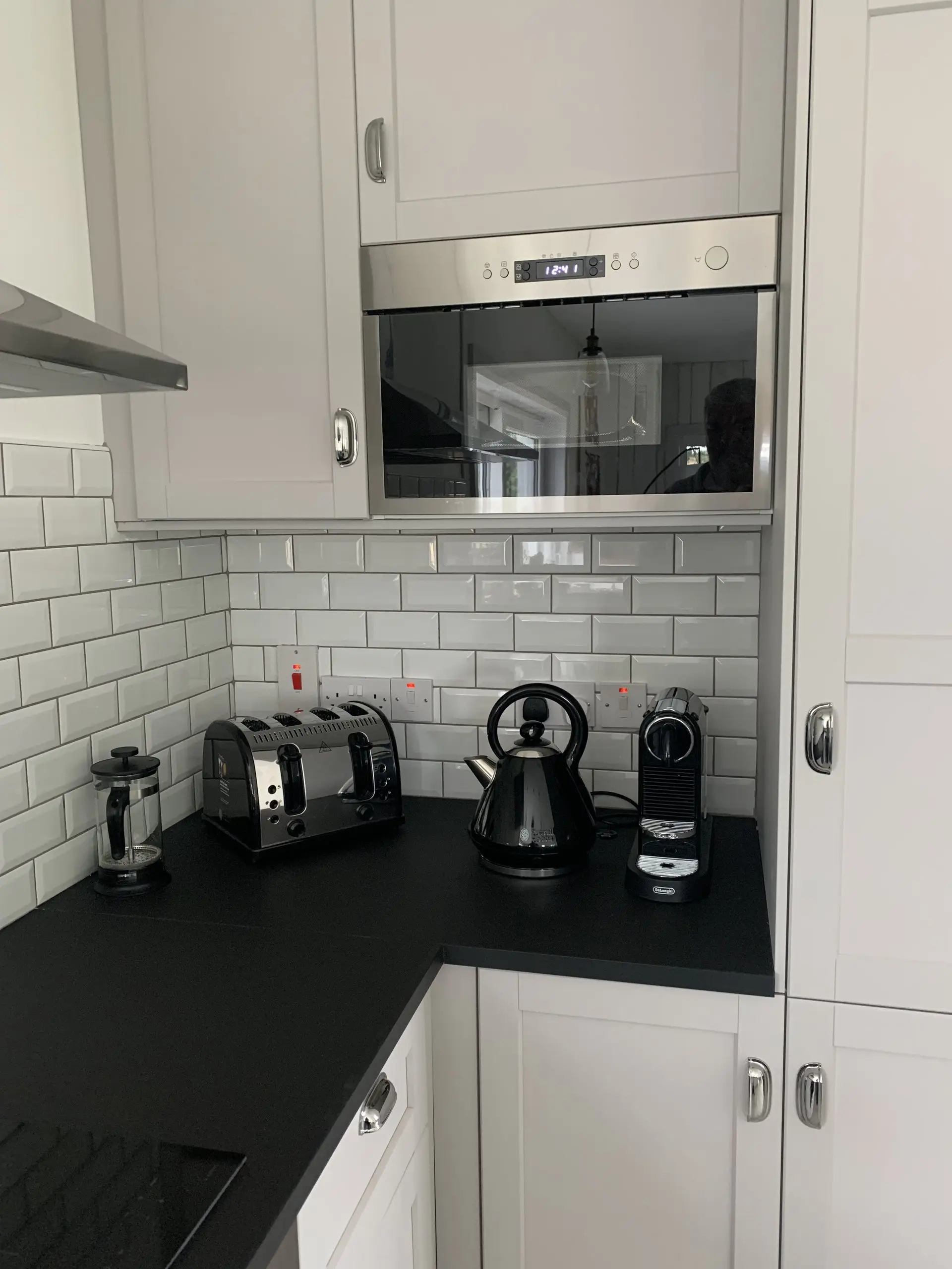 The kitchen worktop with the four-slice toaster, kettle and Nespresso machine, and the microwave above.